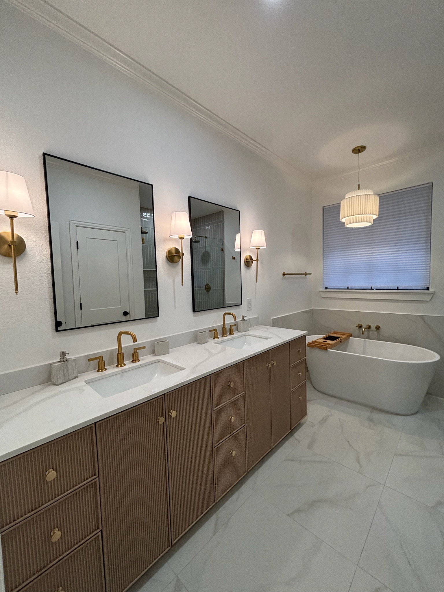 Modern master bathroom after renovation - new vanity, tile, and fixtures